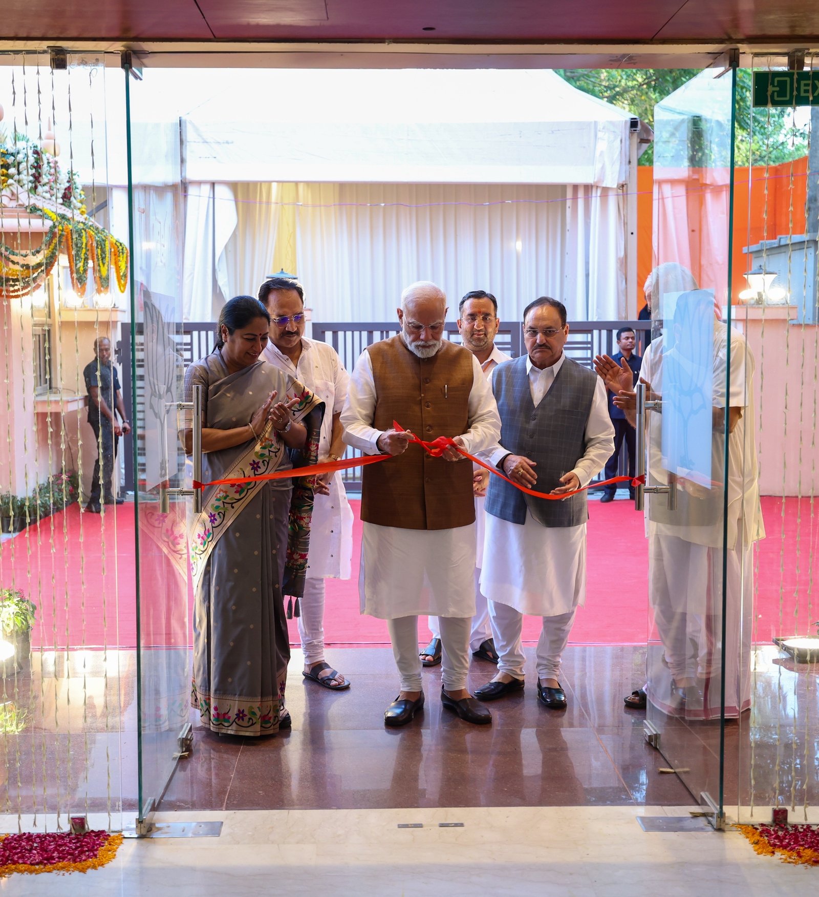 PM Modi inaugurating Delhi BJP office along with CM Rekha Gupta and Delhi BJP chief Virender Sachdeva 